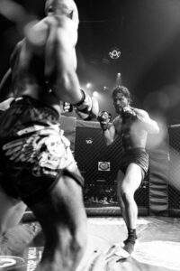 Two MMA fighters grappling against the cage during a Fight Island Championship match in Mallorca